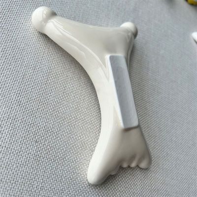 OEM/ODM Gua Sha em forma de X de cerâmica de raspagem Massagista Salão de beleza essencial para relaxamento facial